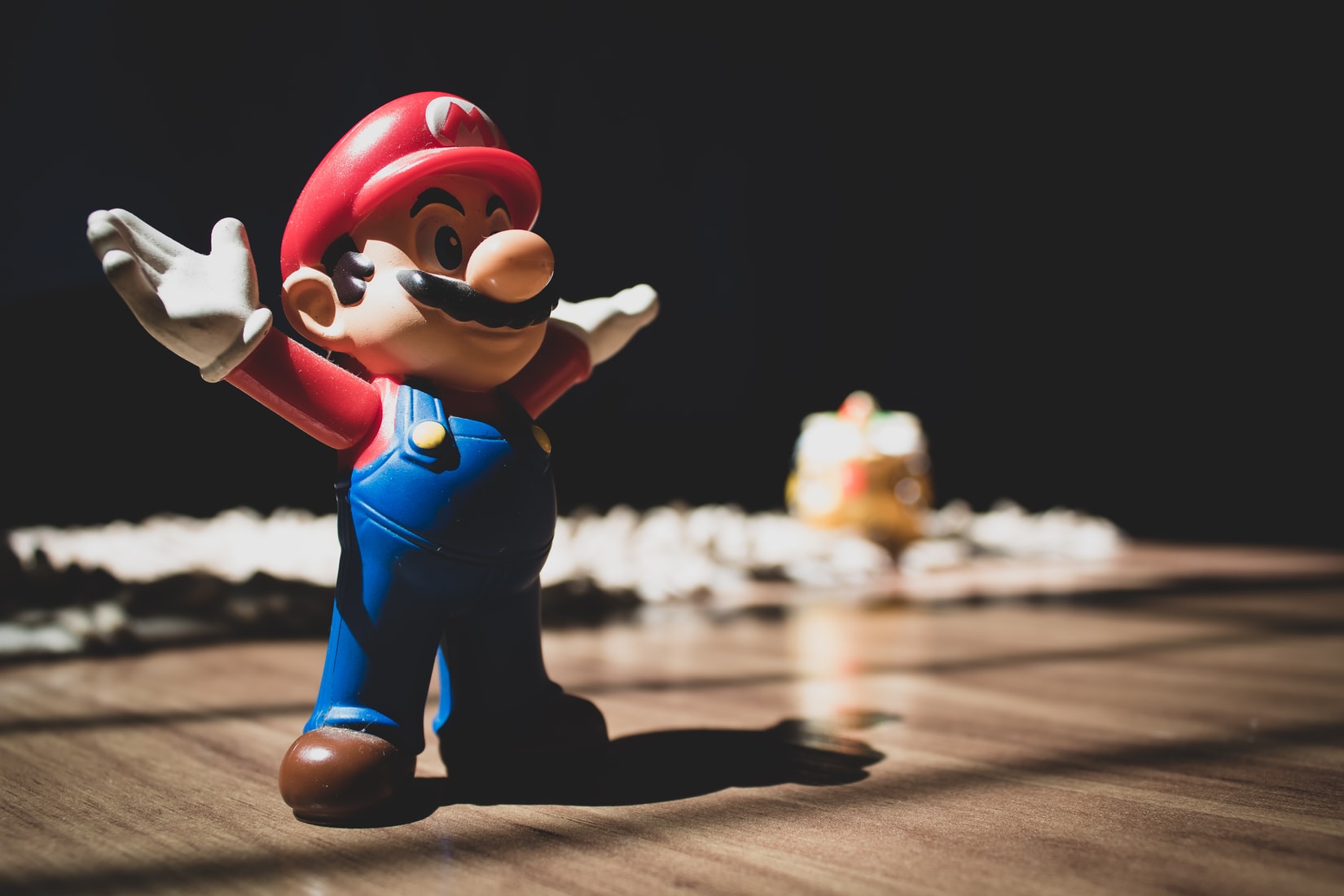 Photo of a Super Mario figurine on brown surface by Cláudio Luiz Castro on Unsplash