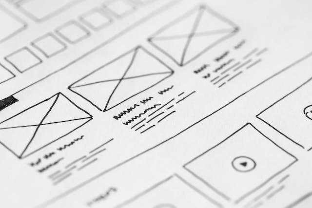 Close-up of wireframes drawn on white paper. 