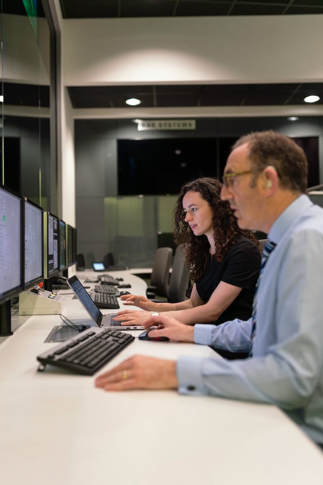 Researchers with computers in a designated research facility. 