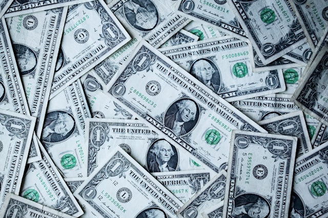 A close-up of a pile of American dollar bills. 
