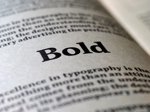 A close-up of a book page. The page displays the word ‘Bold’ in a bold font. 