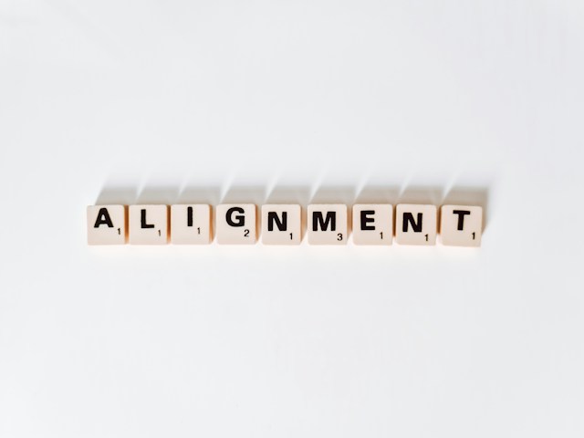 A series of scrabble letters spell out the word ‘alignment’. 