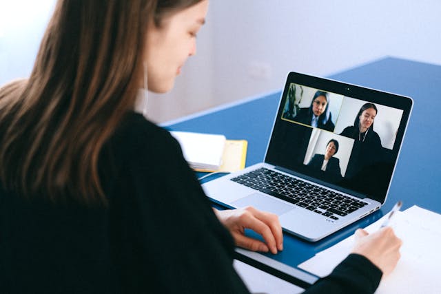 Three people sit in a video conference, conducting a user interview.