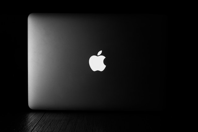 A backlit photo of a MacBook Pro.
