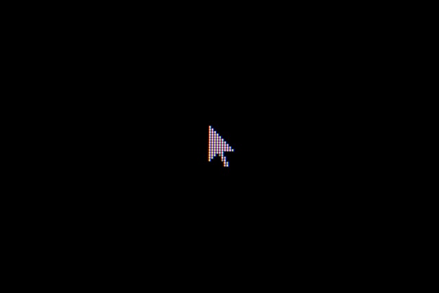 A white, arrow-shaped cursor on a black background with all the pixels visible.
