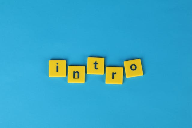 Five yellow tiles spell out the word ‘intro’ against a blue background. 