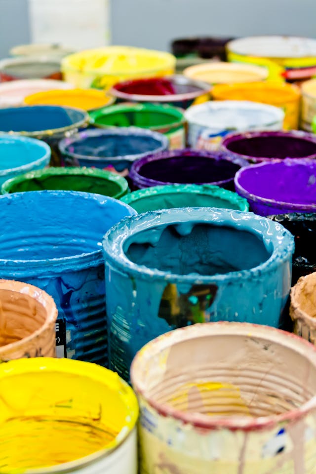 An assortment of differently colored paint buckets that represent variety. 