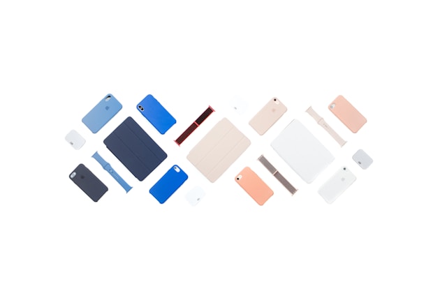 A flat lay of various Apple products in several colors, including MacBooks, phones, and watches.
