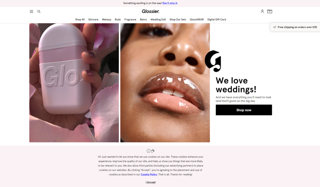 Page Flows screenshot of an example of a colorful conversation cookie banner from Glossier. 