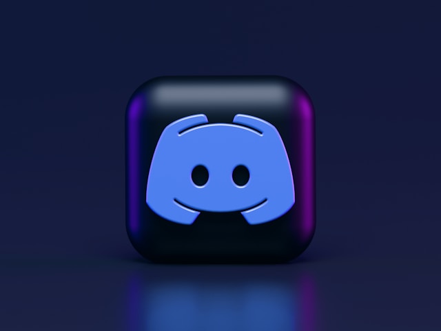 A close-up of a black cube that has the Discord logo on its surface. 
