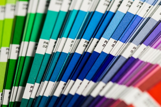 A close-up of a series of differently colored, fanned-out color palettes. 