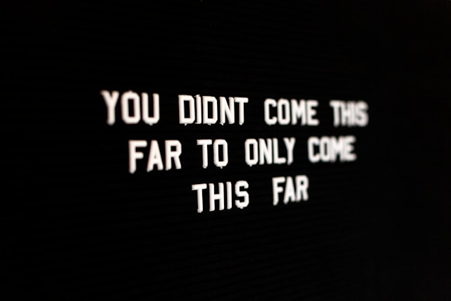 A black background with white text on top of it, reading a motivational phrase.
