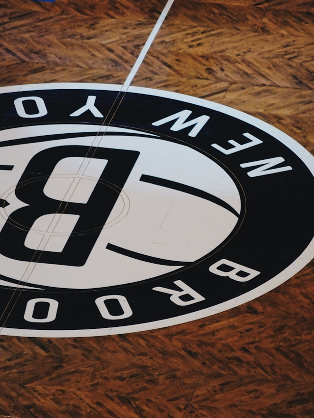 A close-up of the Brooklyn Nets logo on the floor of a basketball court.