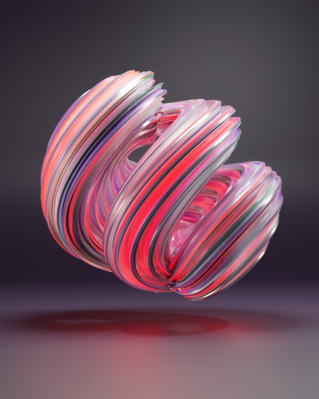 A close-up of an abstract, colorful ball with pink, gray, and purple colors.