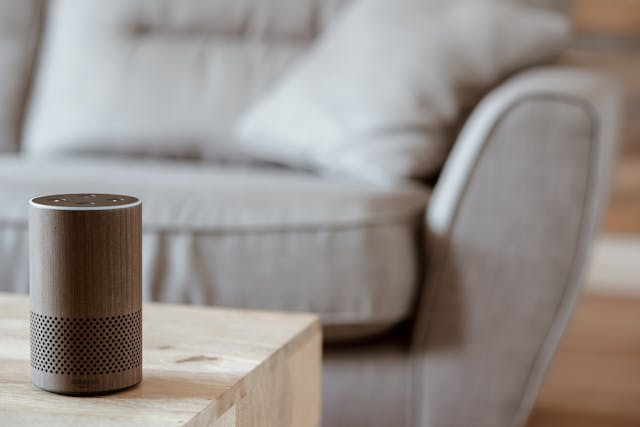 A brown Amazon VUI device placed on a wooden table. 