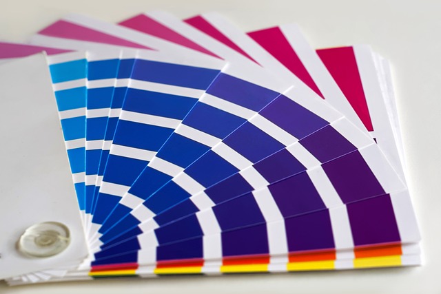 A close-up of a color swatch fan that displays a range of blue and purple colors. 