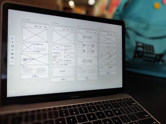 A wireframe visible on a Macbook Pro screen.