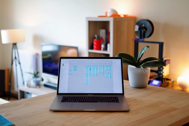 A Macbook on a desk displaying some wireframes.