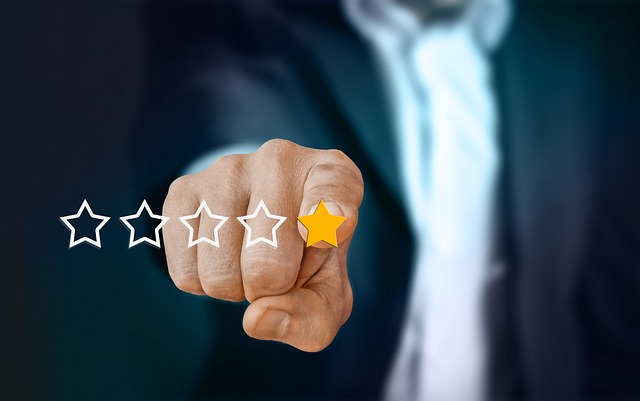 A close-up of a finger pointing at one star out of five stars, representing a negative review.