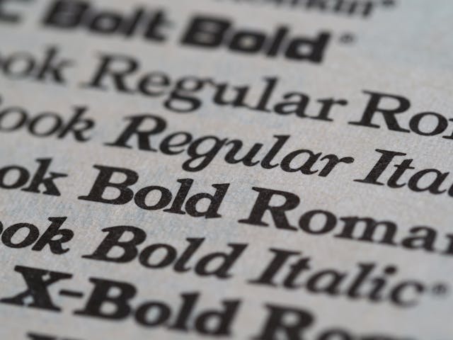 A close-up of a piece of paper containing multiple variations of different fonts, representing the emphasis principle. 
