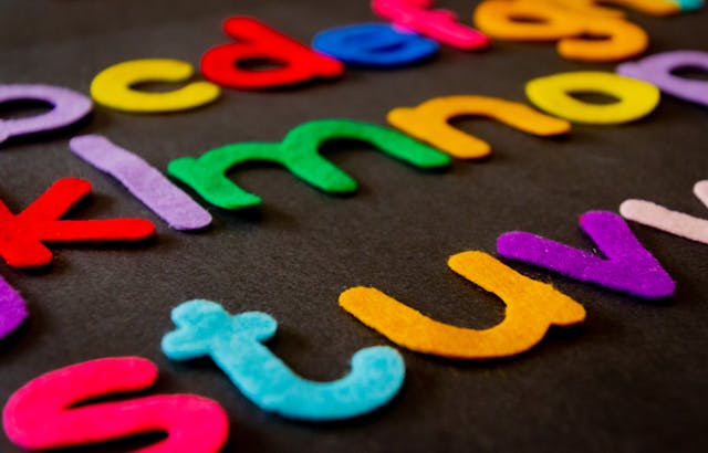 A close-up of a colorful alphabet made out of felt fabric. 

