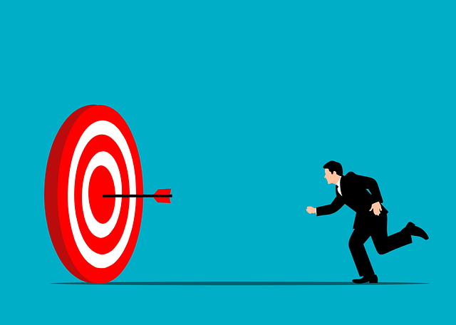 An illustration of a businessman running toward a red and white target with an arrow in it. 
