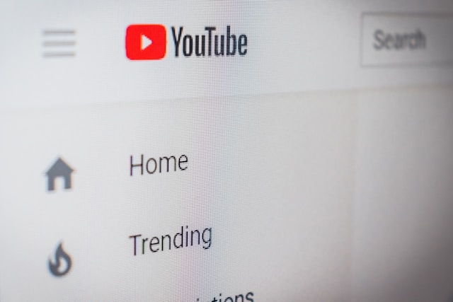 A close-up of the desktop version of YouTube in light mode, displaying the Home and Trending tab.