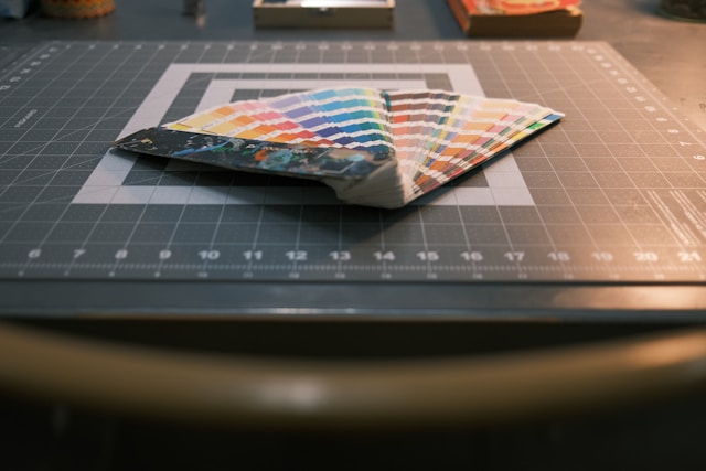 Color palettes on a grey surface.
