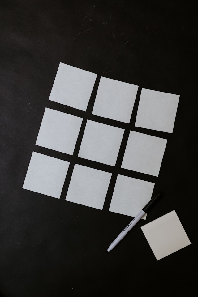 A bird’s-eye view of a group of white cards representing a card sorting session. 
