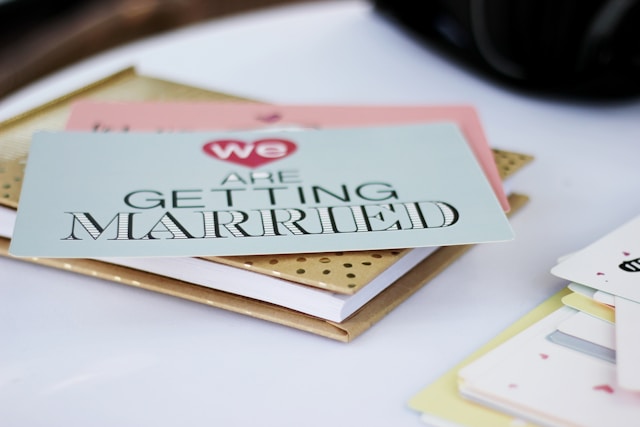 A close-up of a light blue wedding invitation card that reads the phrase “We are getting married.”
