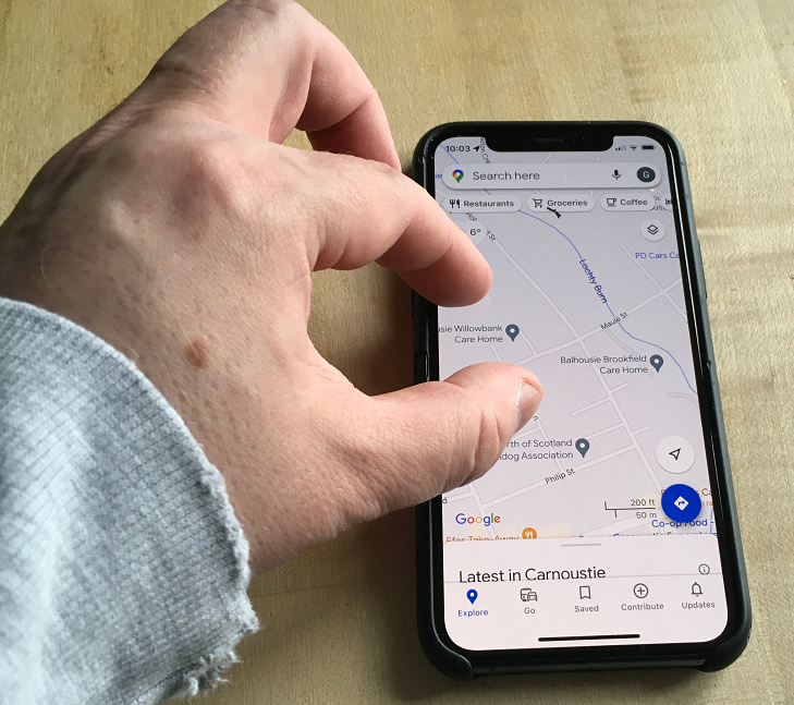 A Page Flows screenshot of someone pinching their phone screen from Tetra Logical. 
