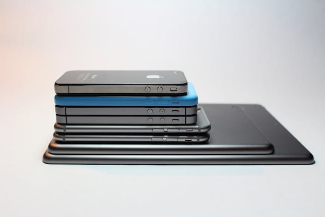 A close-up of a neat assortment of phones and smart tablets.  
