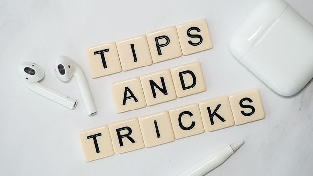 An assortment of off-white tiles display letters that spell out the phrase “Tips and Tricks.”
