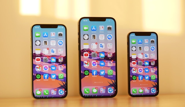Three iPhones displaying home screens with various well designed apps.