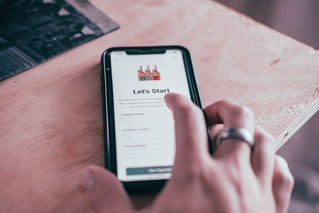 A person about to tap on the log-in page of a site on a black Android smartphone app.
