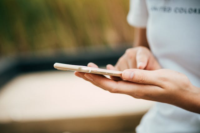 A close-up of someone tapping a button on a phone, representing interactivity. 