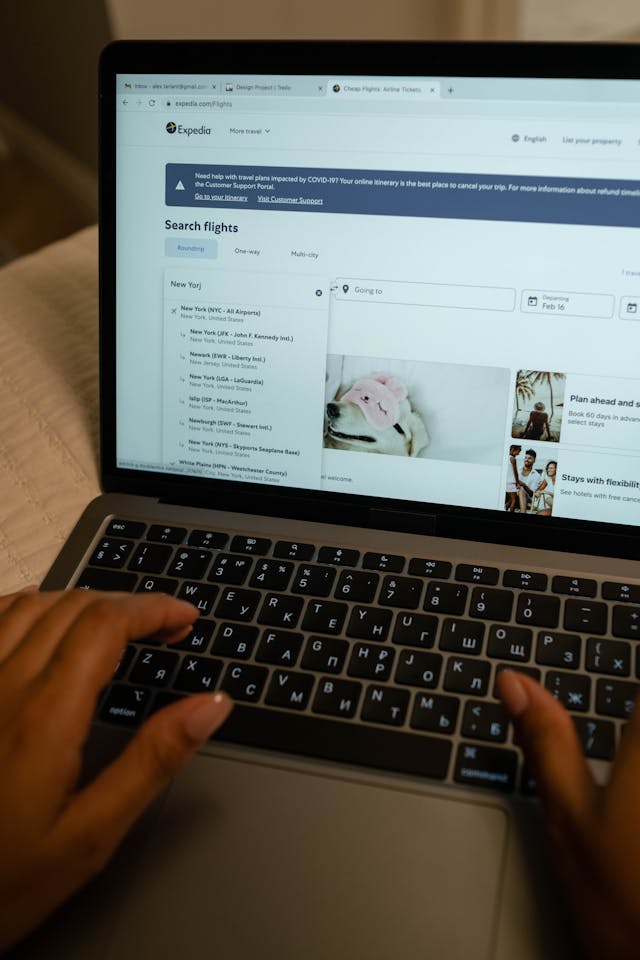 A person searching for flights on the Expedia homepage.